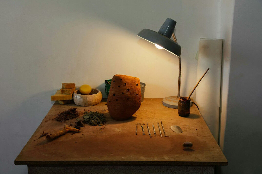 Studio desk with a camera and notebook ready for work