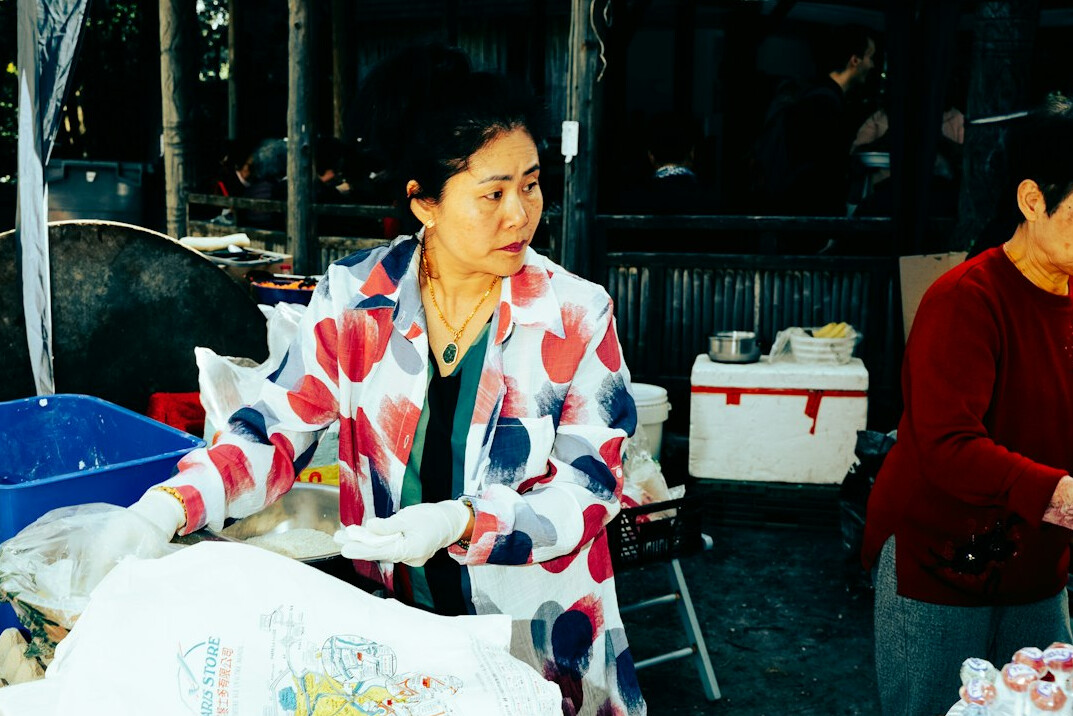 Vendor at a local outdoor market stall