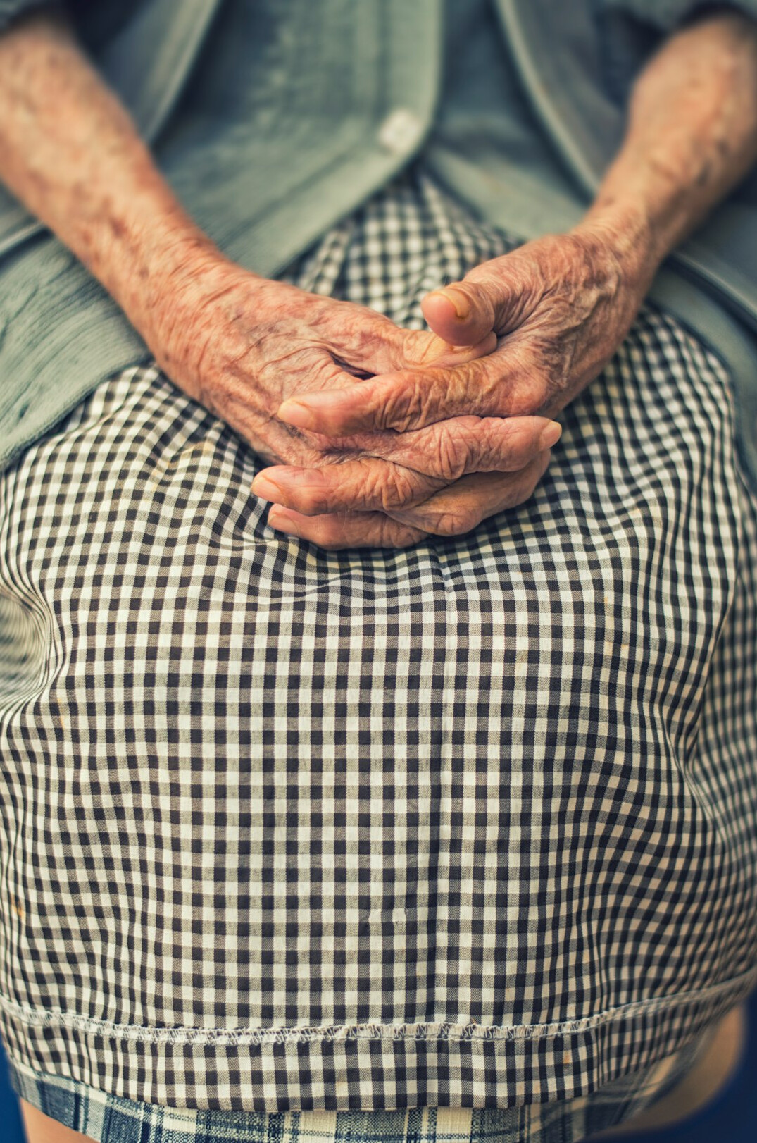 Close-up of an elderly person's weathered hands