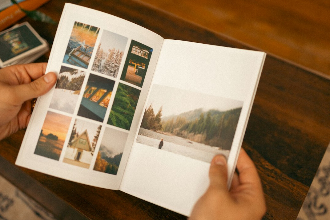 Team reviewing printed photographs spread on a table